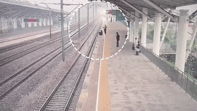 列车即将进站,两名客运员拼命跑向一名旅客 列车即将进站,两名客运员拼命跑向一名旅客