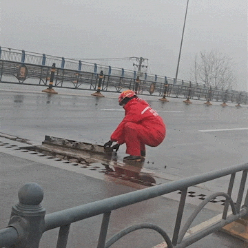 大雨中,男子徒手按下几十公斤重钢板 大雨中,男子徒手按下几十公斤重钢板