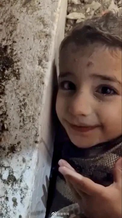 救援人员给废墟下男孩喂水 男孩露出笑容