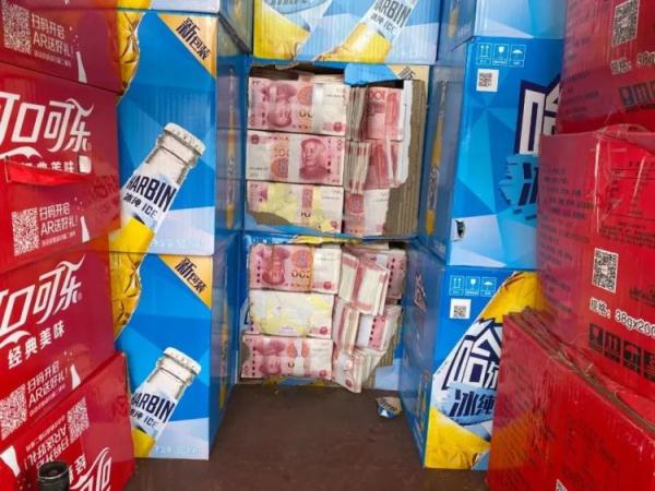 发现载货车辆车厢底部的14个啤酒纸箱内夹藏有大量人民币现金,经清点