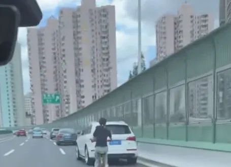 上海高架路惊现一赤膊男子紧贴工程车骑行，市民：已不止一次！