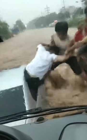 “不只我一个人救！”白色小车被困洪水中，男子脚垮激流抡锤砸窗救出3人