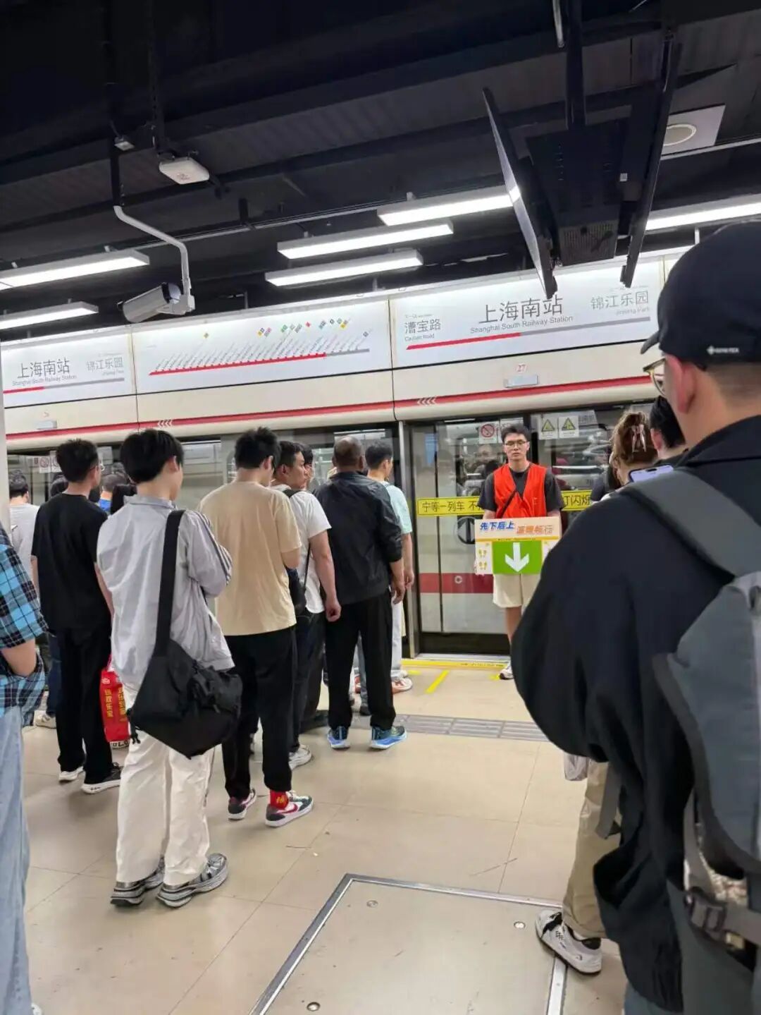 专人举牌督促乘客“先下后上”，网友：管住不自觉的人；上海地铁回应